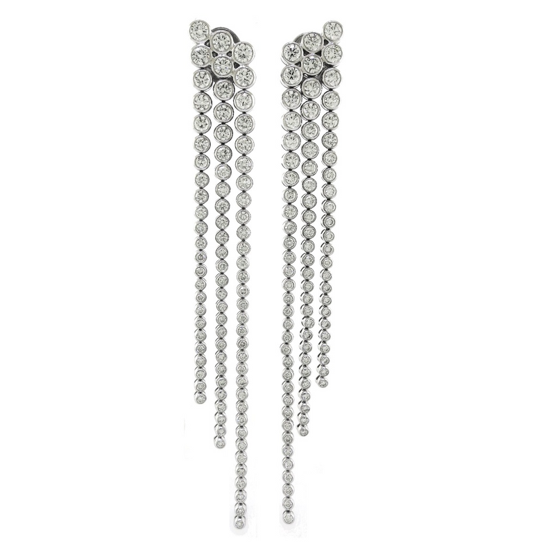 A pair of 18ct white gold diamond bezel set long drop layered earrings