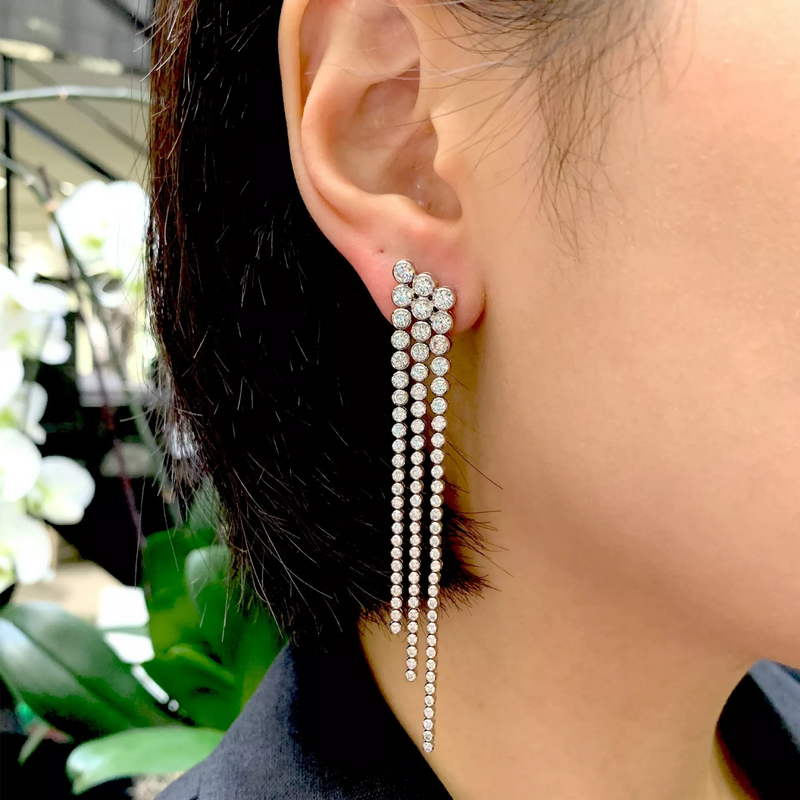 18ct white gold diamond bezel set drop earrings on the ear