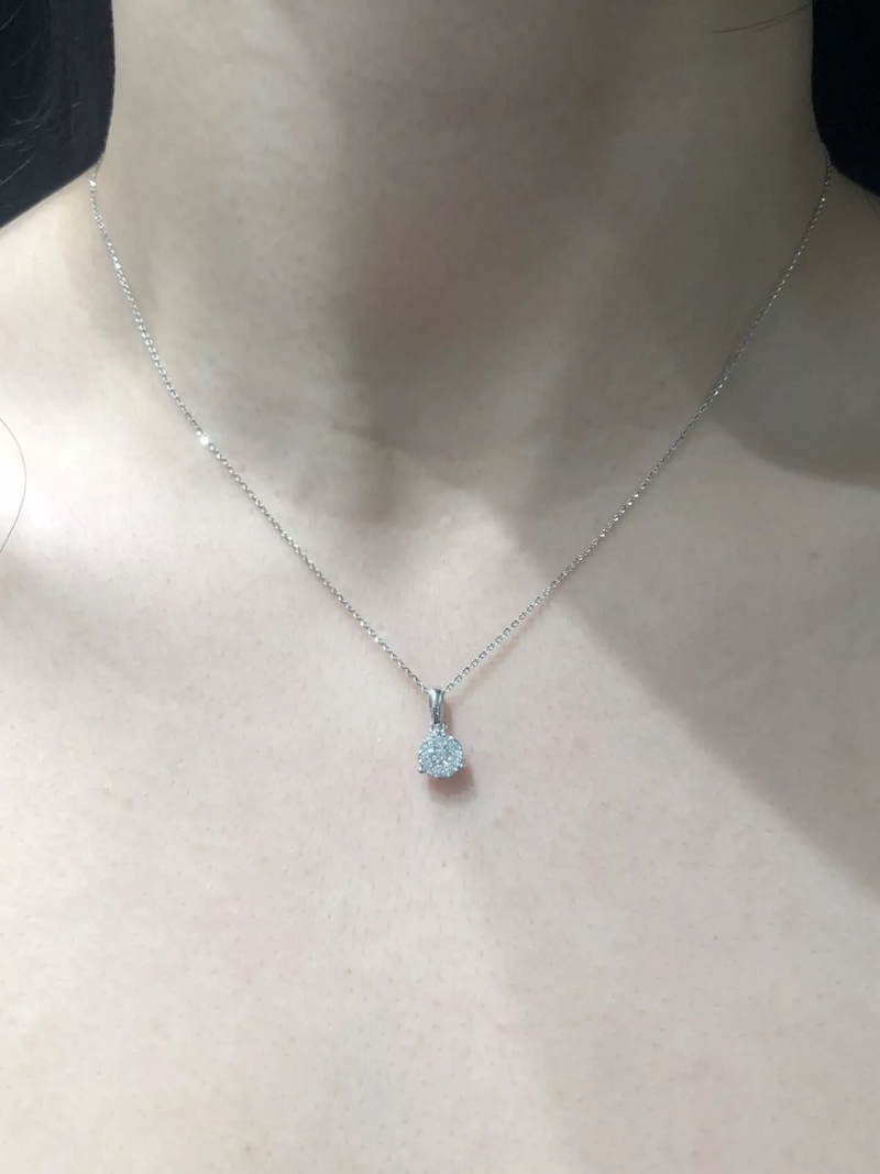 18ct white gold round cluster diamond necklace with a bale displayed on the neck