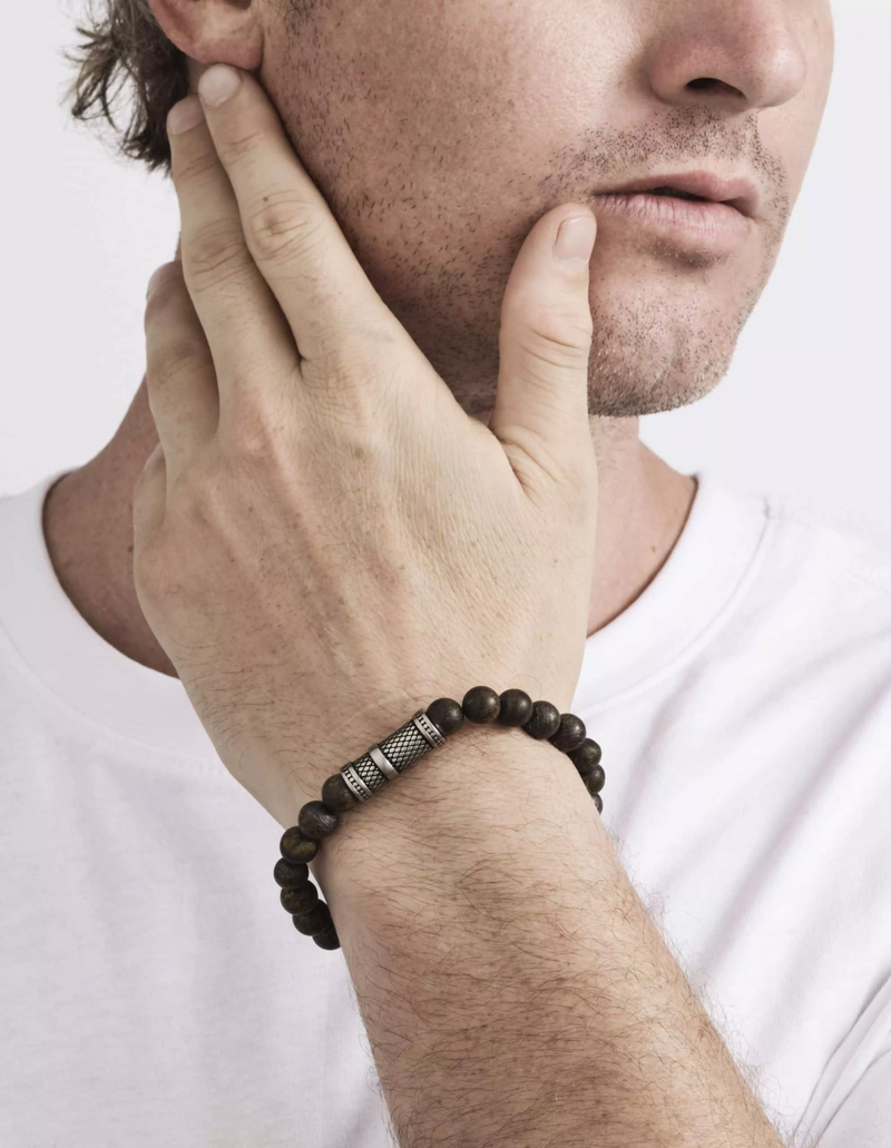 Bronzite and stainless steel beaded stretchy men's bracelet on the wrist