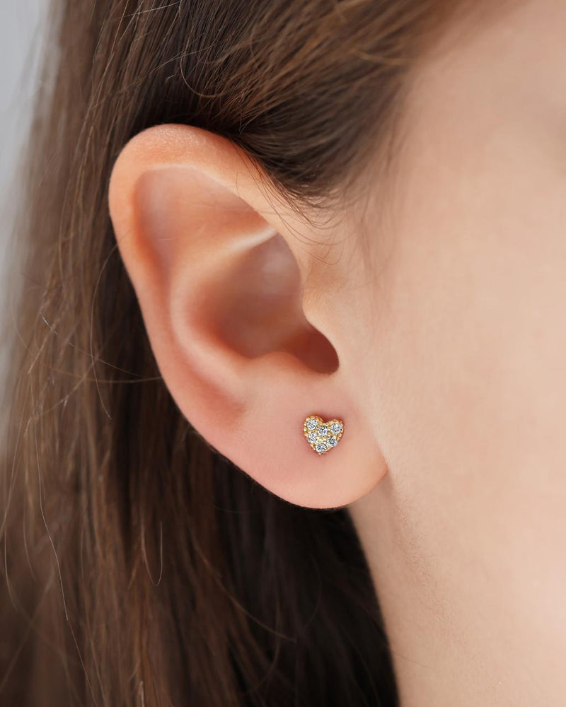 18ct yellow gold cubic zirconia heart stud earrings on the ear