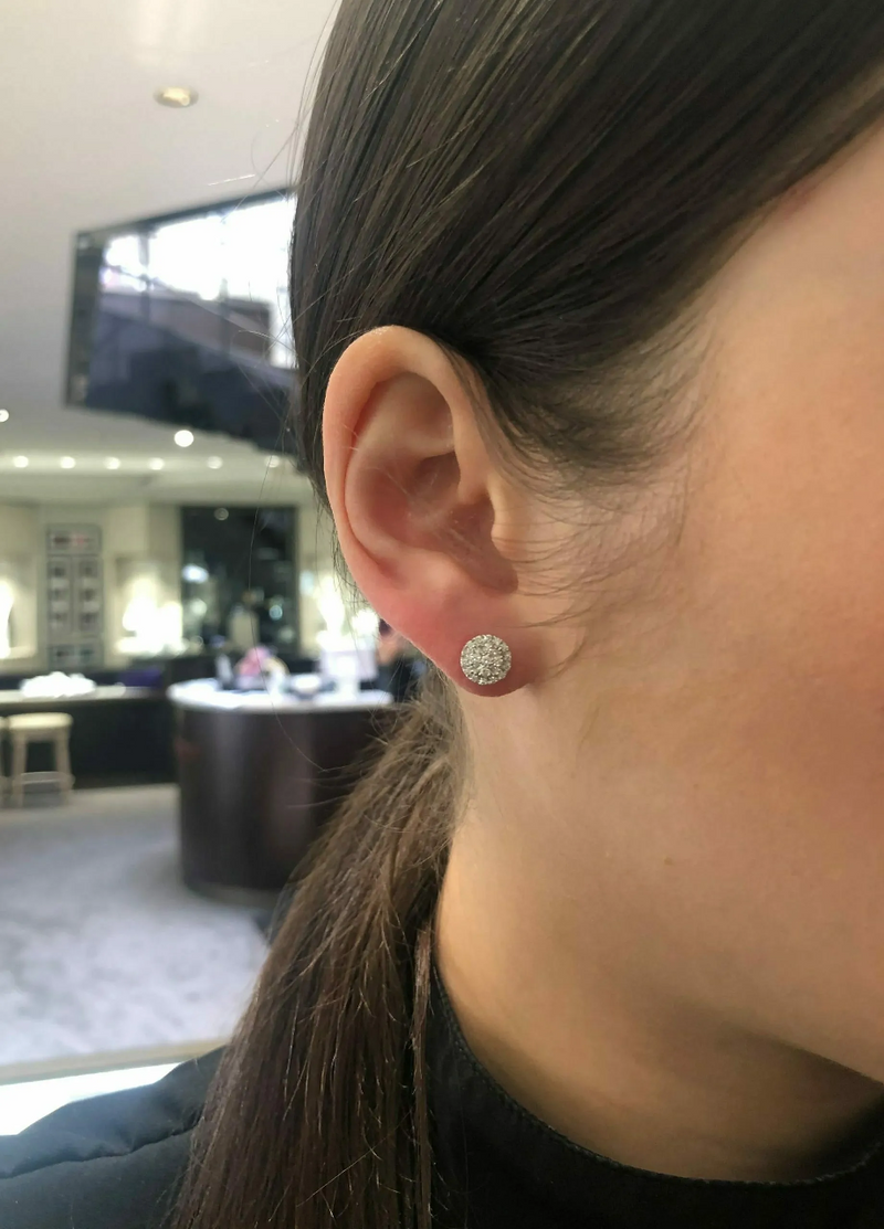 18ct white gold round shape baguette and round cut diamond cluster stud earrings on the ear
