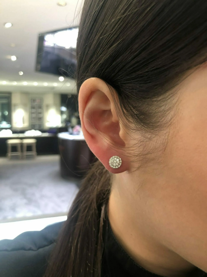 18ct white gold round shape baguette and round cut diamond cluster stud earrings on the ear