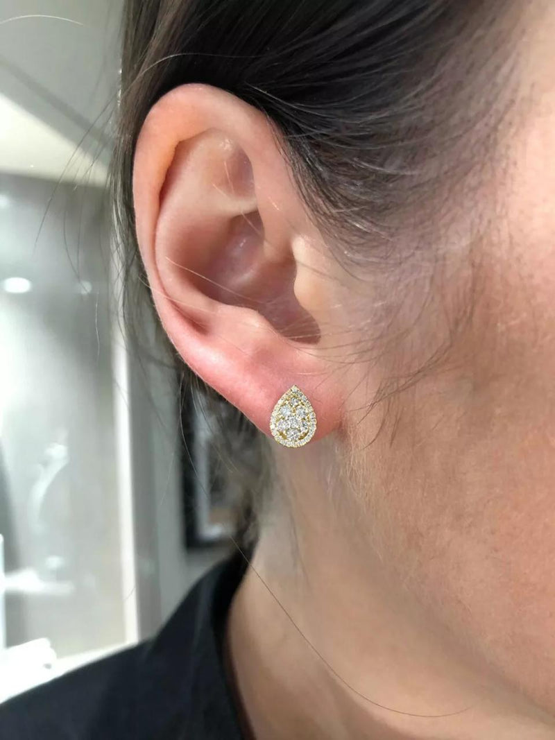 18ct yellow gold 60=0.56ct round brilliant cut diamond cluster earrings on ear
