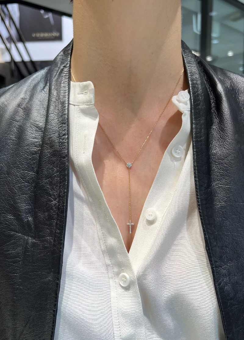 18ct yellow gold diamond drop cross necklace on the neck