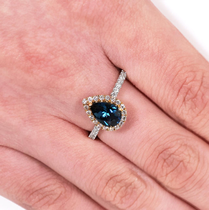 18ct white and yellow gold pear shape London blue topaz and diamond ring on the finger