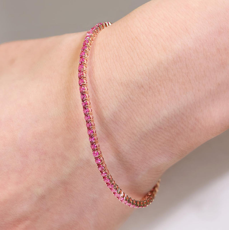 18ct rose gold 3.77ct round pink sapphire four claw set bracelet on the wrist