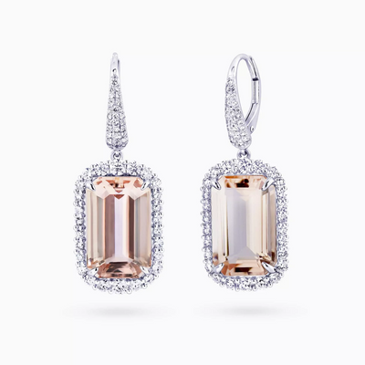 A pair of 18ct white gold earrings featuring emerald cut morganite stones with round brilliant cut diamond halos.