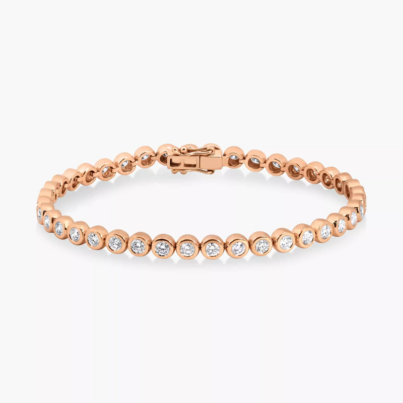 An 18ct rose gold round diamond bezel tennis bracelet with multiple round brilliant cut diamonds set in a continuous pattern.