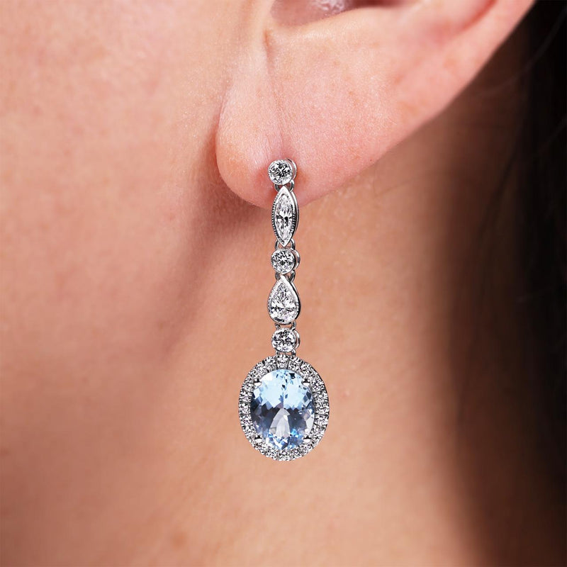 18ct white gold oval cut aquamarines and diamond drop earrings on the ear