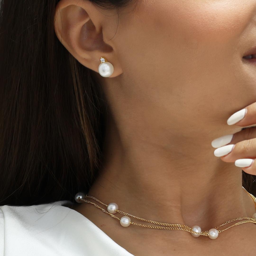 18ct yellow gold 10mm near round white South Sea pearl and diamond stud earrings on the ear