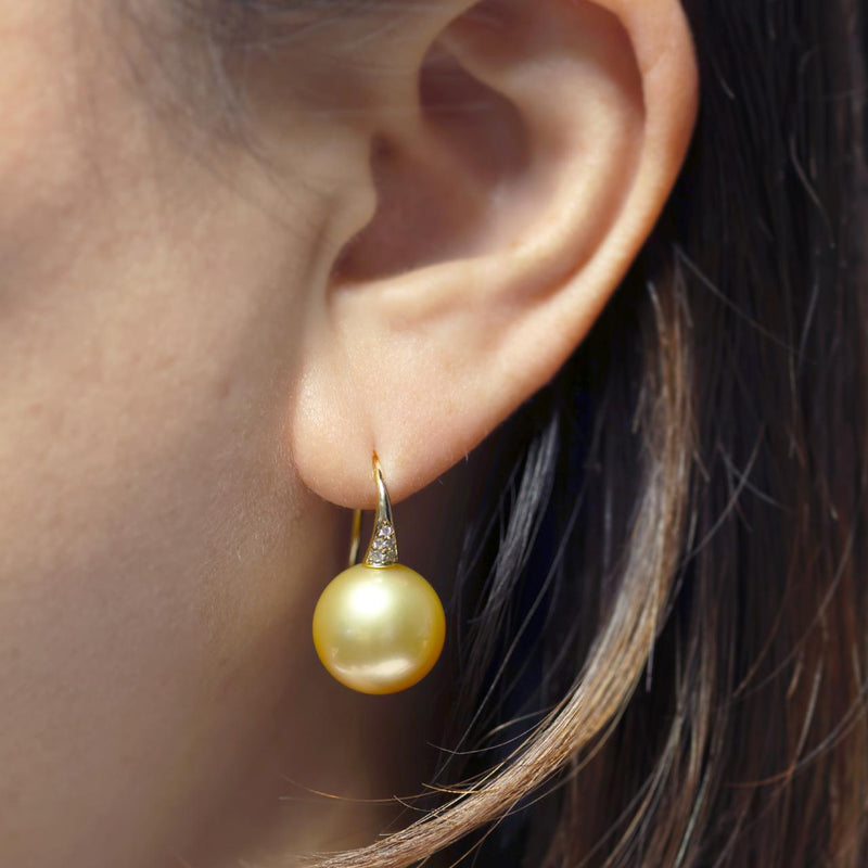18ct yellow gold 13mm gold south sea pearl and round brilliant cut diamond drop hook earrings on the ear
