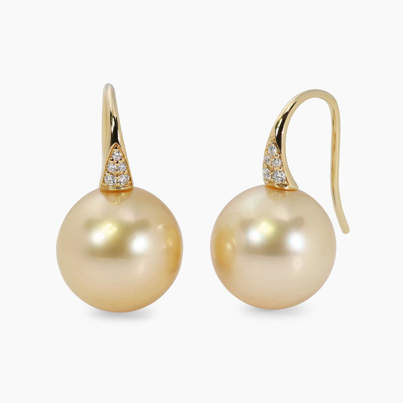 A pair of 18ct yellow gold drop hook earrings featuring 13mm gold south sea pearls and round brilliant cut diamonds.