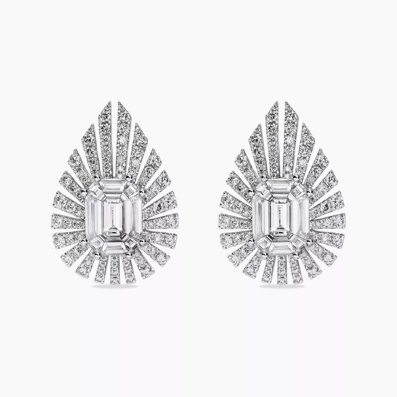 A pair of 18ct white gold baguette and round diamond earrings with a central emerald cut diamond surrounded by smaller baguette and round brilliant cut diamonds.