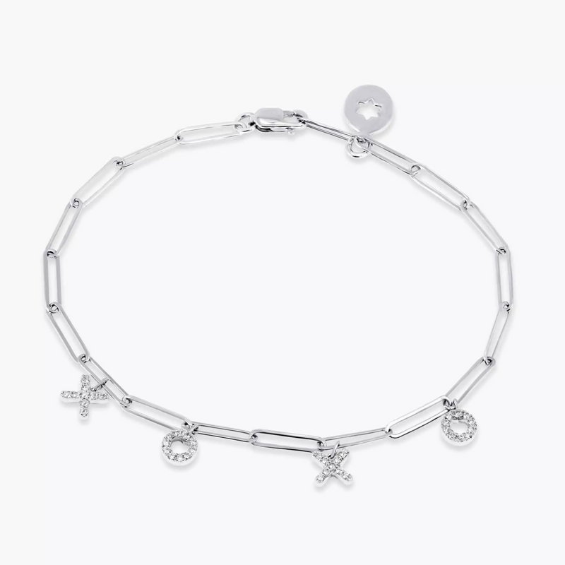 An 18ct white gold diamond paperclip bracelet with 'xo' charms on a white background.