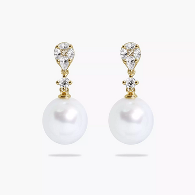 A pair of 18ct yellow gold drop earrings featuring 10mm South Sea pearls and various cuts of diamonds, including marquise, pear, princess, and round brilliant.