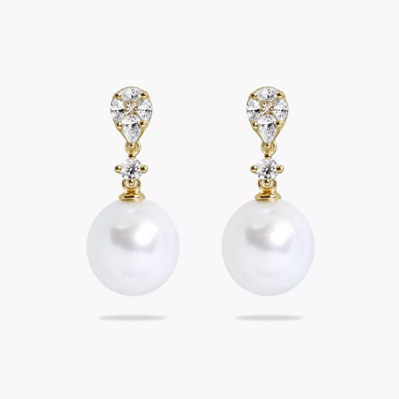A pair of 18ct yellow gold drop earrings featuring 10mm South Sea pearls and various cuts of diamonds, including marquise, pear, princess, and round brilliant.