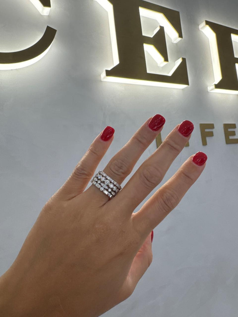 18ct white gold baguette and round brilliant cut diamond dress ring on the finger