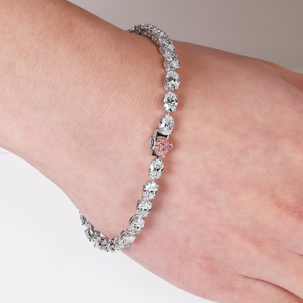 Platinum and rose gold 26=13.13ct oval white and Argyle Pink diamond diamond tennis bracelet on wrist