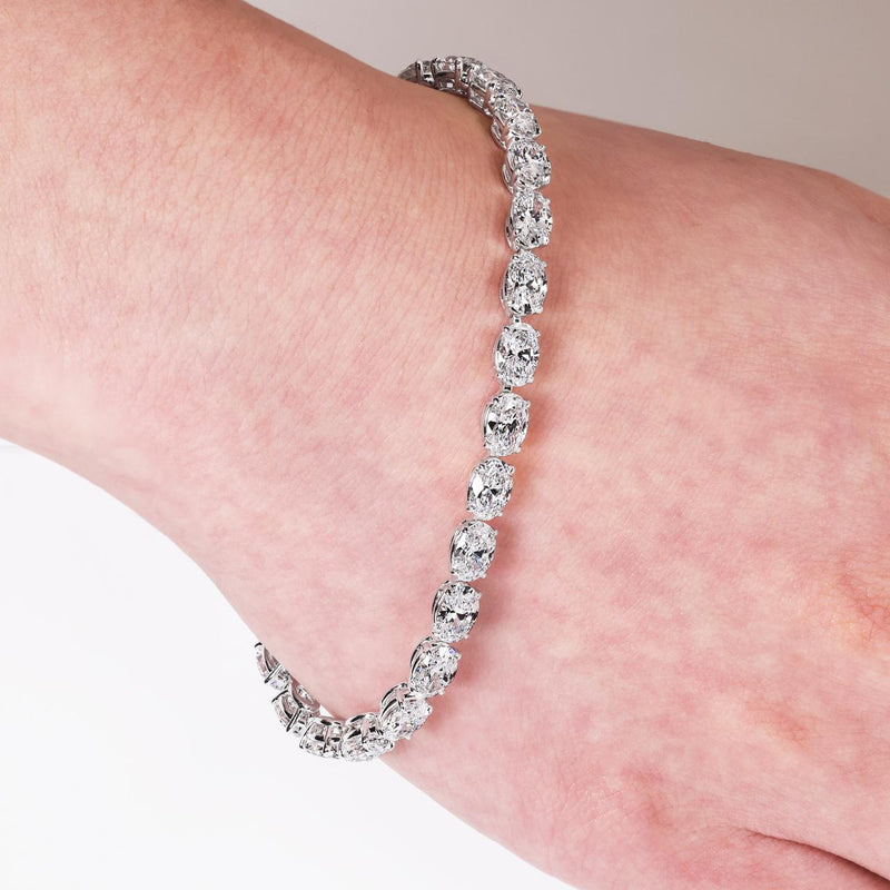 Platinum and rose gold 26=13.13ct oval white and Argyle Pink diamond diamond tennis bracelet on the wrist