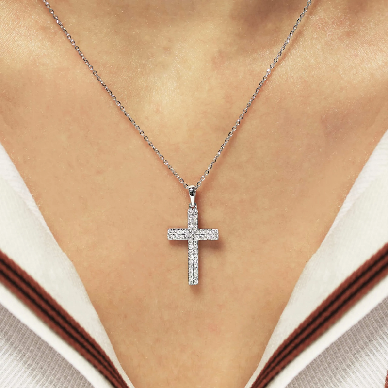 18ct white gold diamond cross necklace displayed on the neck