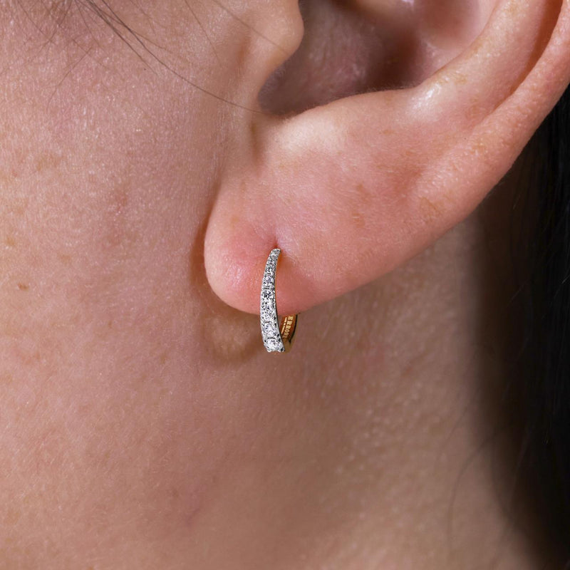 18ct yellow gold graduating diamond hoop earrings on the ear