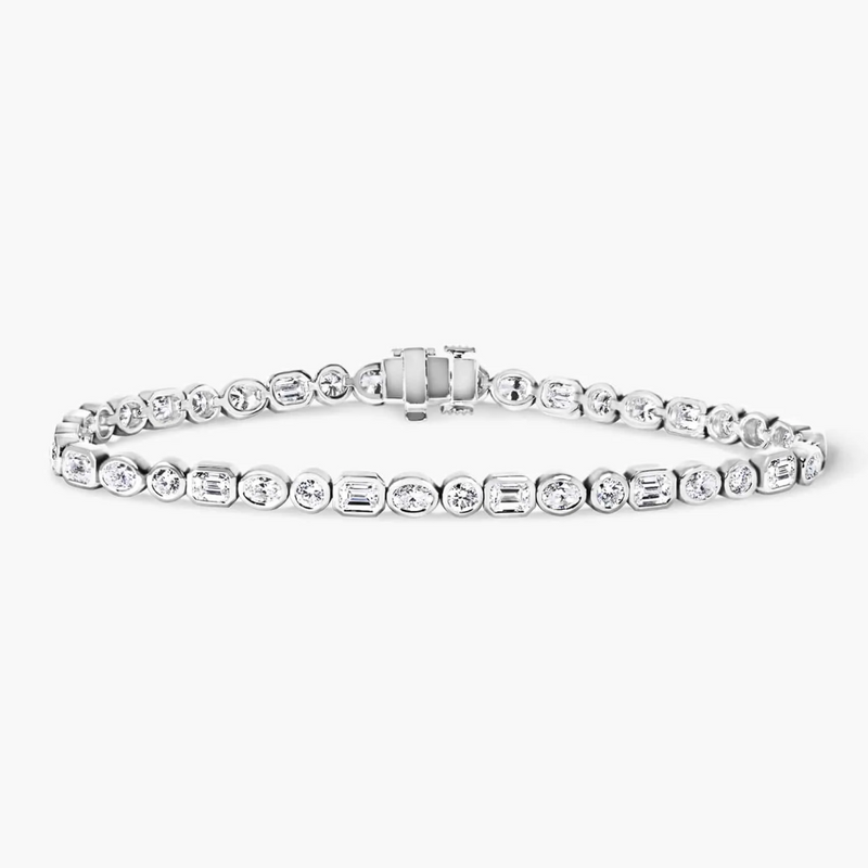 An 18ct white gold bracelet with round, oval, and emerald cut diamonds.