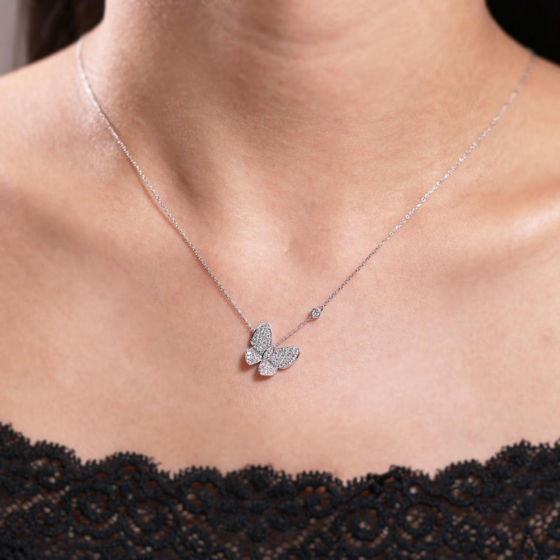 18ct white gold diamond set butterfly necklace with bezel set single diamond on the neck