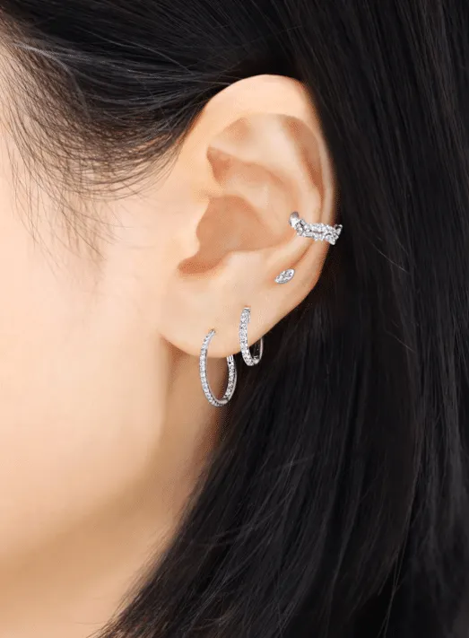 white gold diamond hoop earrings on the ear