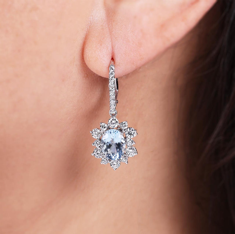 18ct white gold oval aquamarines and diamond drop earrings on the ear