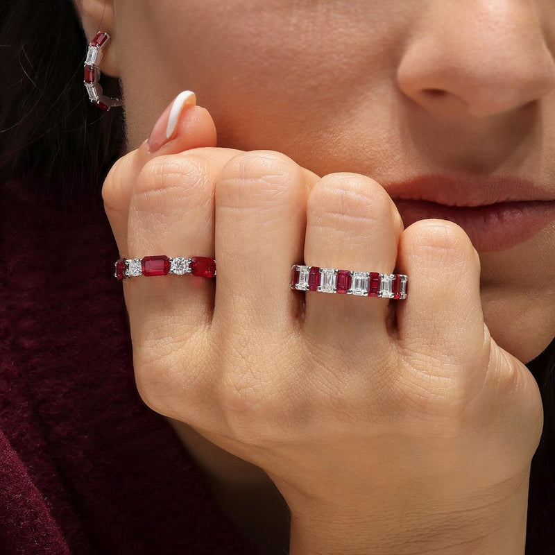 18ct white gold emerald cut ruby and round brilliant cut diamond ring on the finger