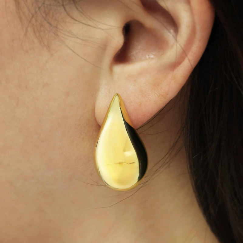 18ct yellow gold tear drop earrings on ear