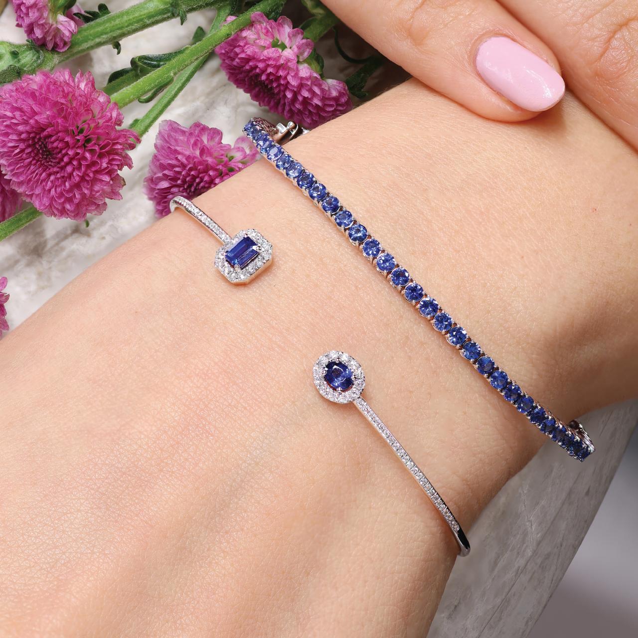 18ct white gold 0.62ct oval and emerald cut blue sapphire and diamond open bangle and round brilliant cut blue sapphire tennis bracelet