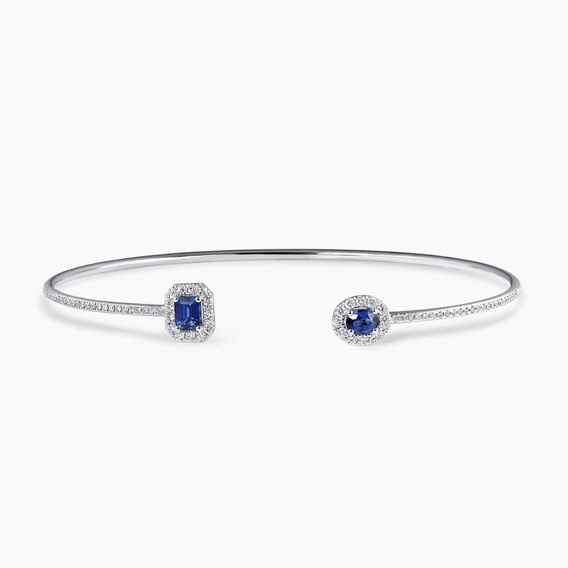 18ct white gold 0.62ct oval and emerald cut blue sapphire and diamond open bangle