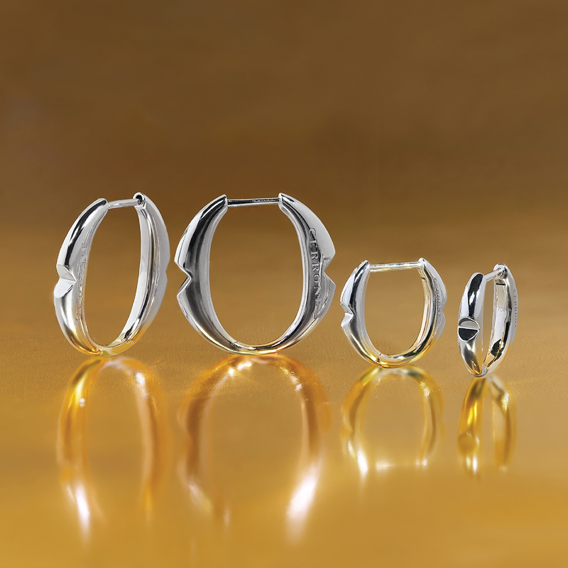 A pair of 18ct white gold small 'O' hoop earrings from the Iconica Collection beside the large size hoop to compare size