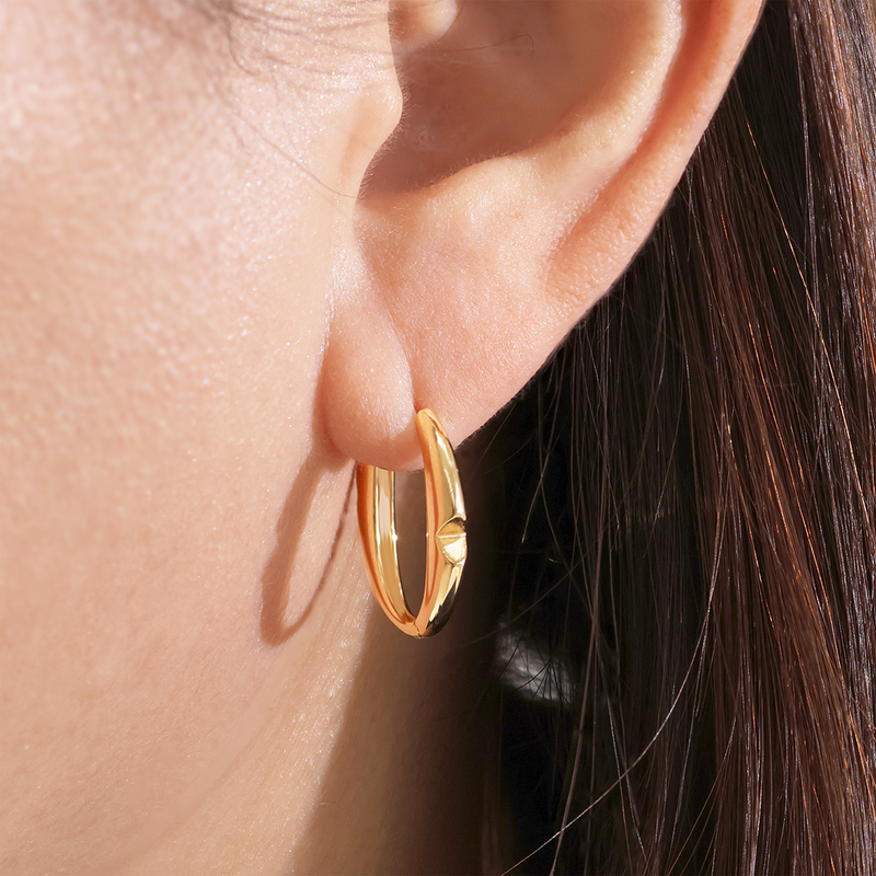 18ct yellow gold large ‘O’ hoop earrings from the Iconica Collection on the ear