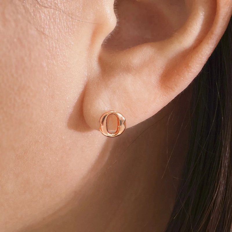 A pair of 18ct rose gold large 'O' stud earrings from the Iconica Collection on the ear