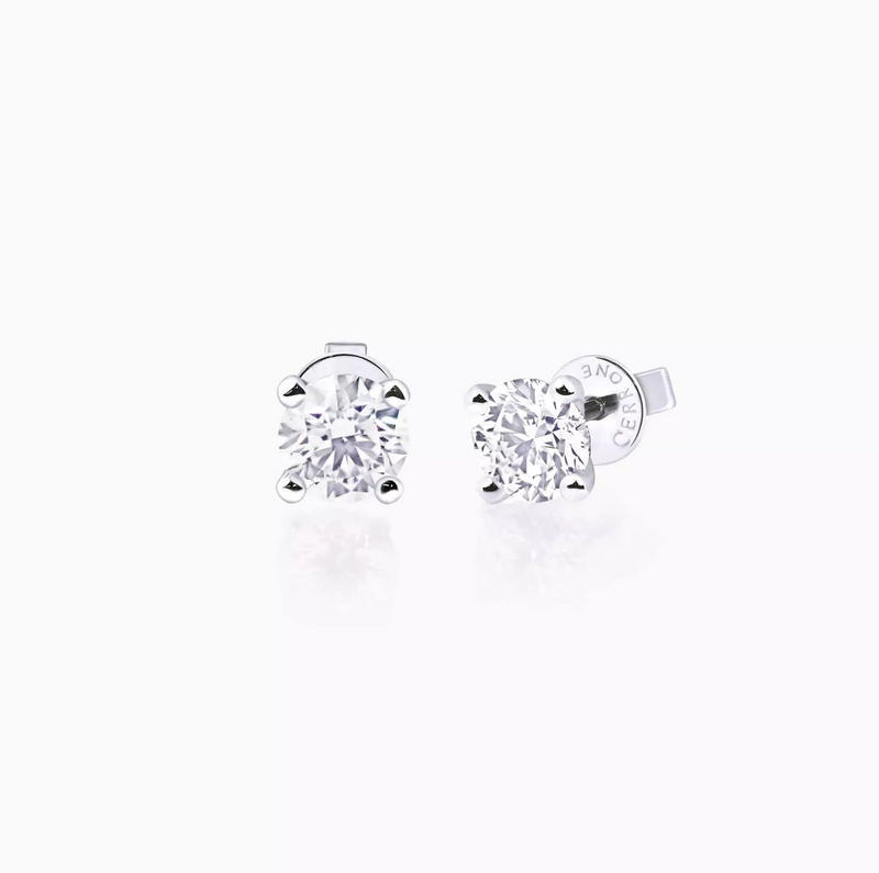 A pair of 18ct white gold round brilliant cut diamond stud earrings with a four claw setting.