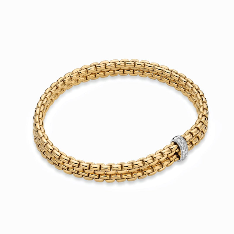 18ct yellow gold flexible 'FOPE' bracelet with an 18ct white gold diamond set rondel