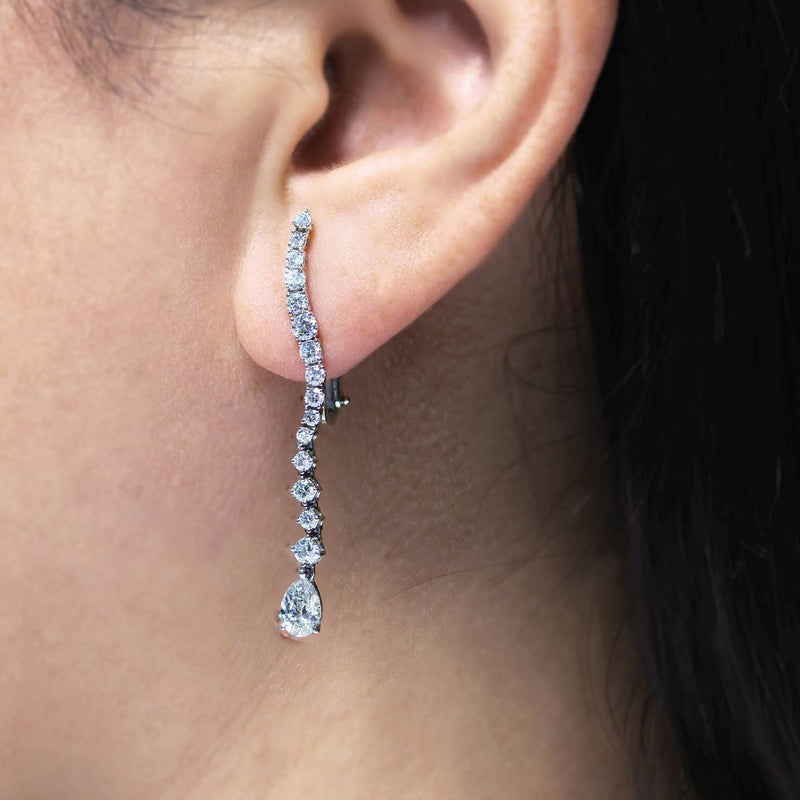 18ct white gold pear and round brilliant cut diamonds drop earrings on ear