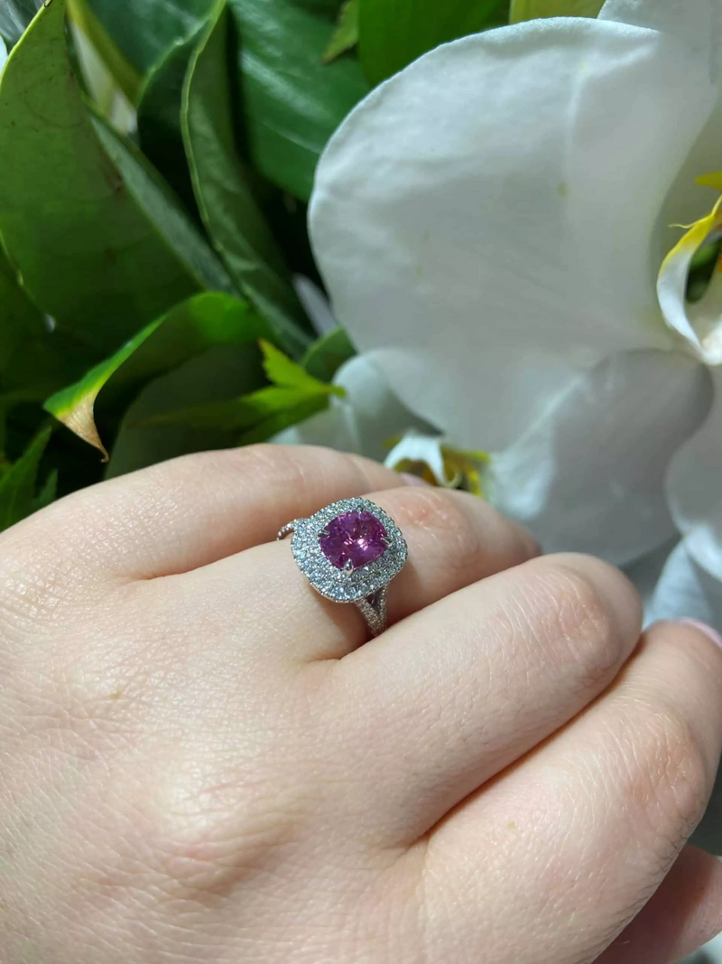 18ct white gold cushion cut pink sapphire and diamond double halo ring on the finger