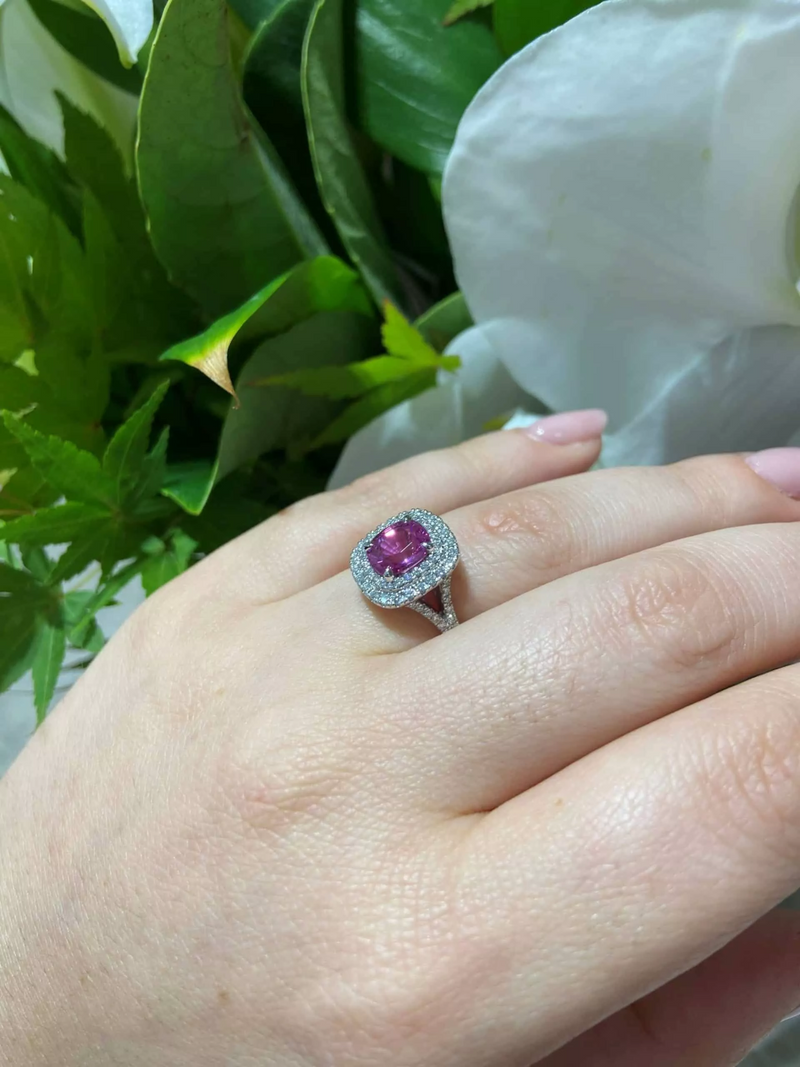 18ct white gold cushion cut pink sapphire and diamond double halo ring on the finger