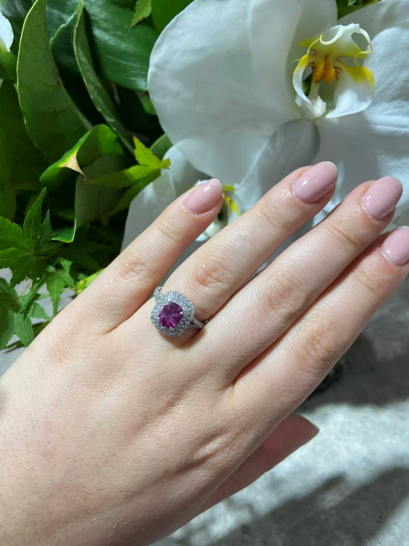 18ct white gold cushion cut pink sapphire and diamond double halo ring on the finger