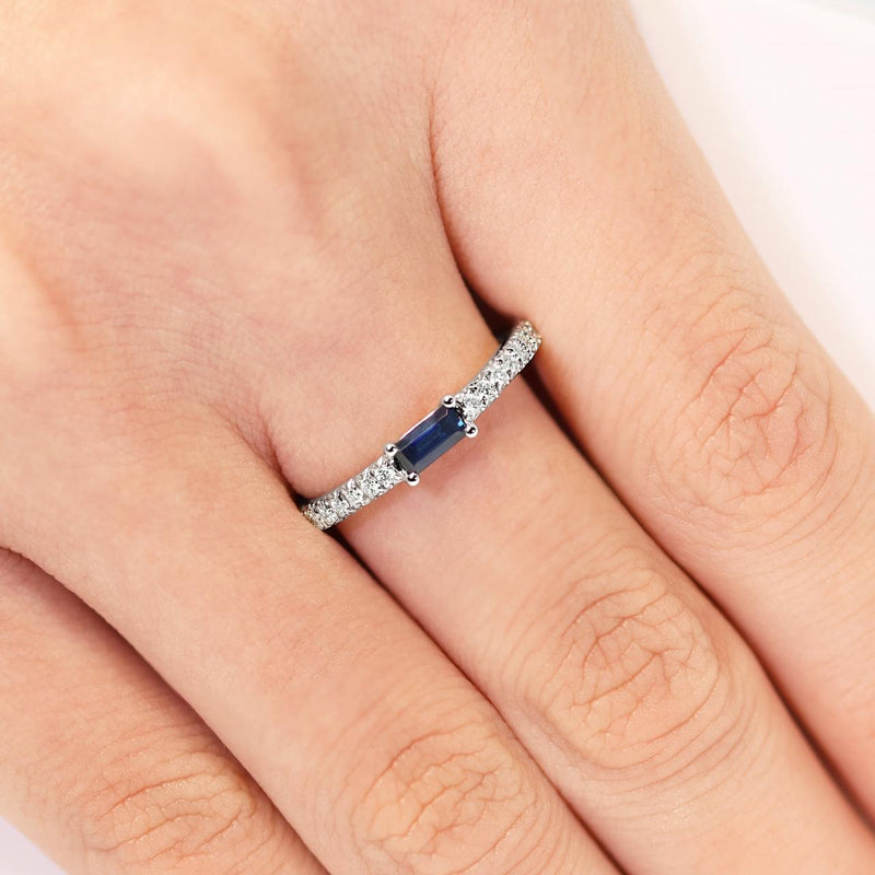 Platinum emerald cut Australian sapphire and diamond ring on the finger