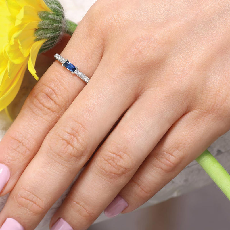 Platinum emerald cut Australian sapphire and diamond ring on the finger