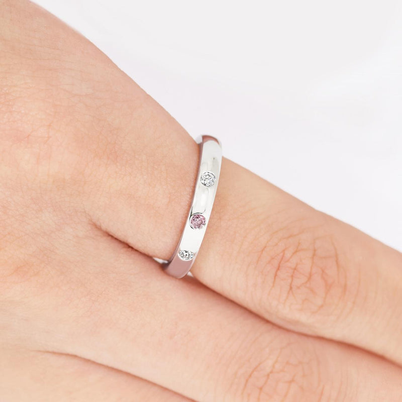 18ct white gold round brilliant cut pink and white diamond drop set ring on the finger