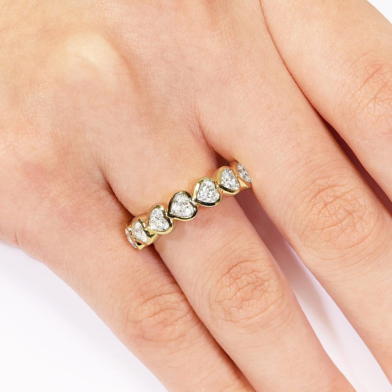 18ct yellow gold heart shape bezel set diamond ring on the finger