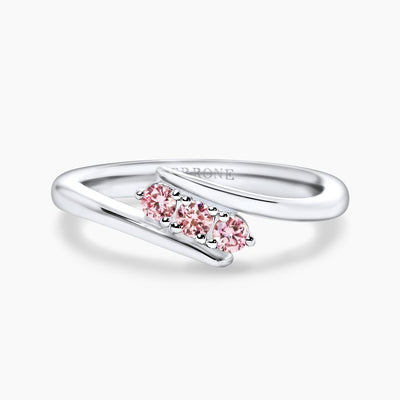 An 18ct white gold round brilliant cut Argyle pink diamond ring with three visible round pink diamonds in a claw setting.