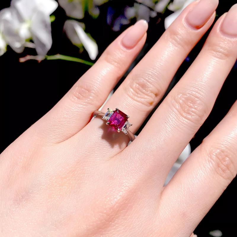 Platinum Mozambique emerald cut ruby and diamond ring on the finger