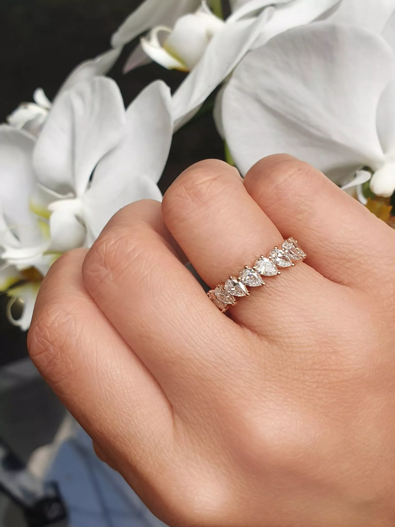 18ct rose gold pear shaped diamond full circle ring on the finger